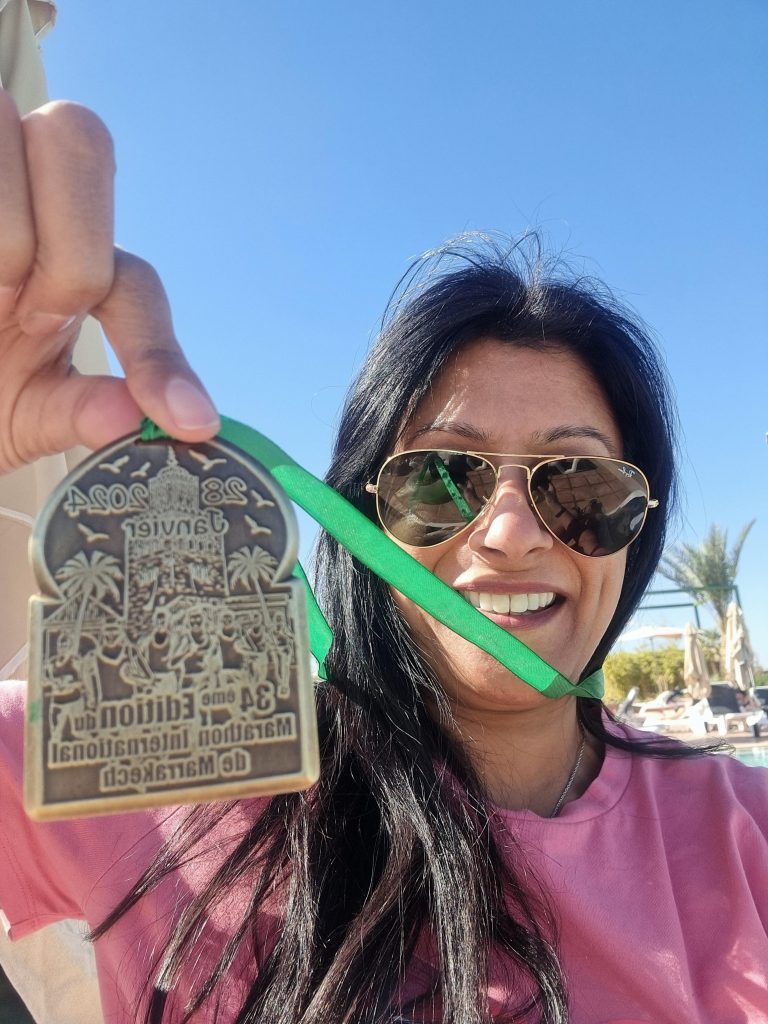 Naz Zaman holding a medal