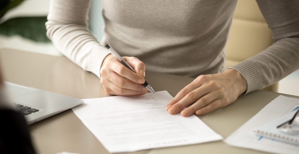 Woman signing a document