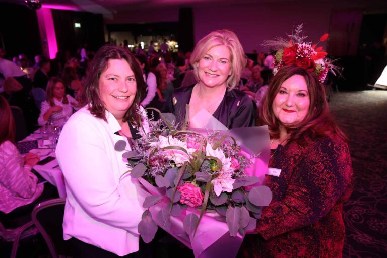 Image of three women holding flowers at the Merseyside Women of the Year Awards