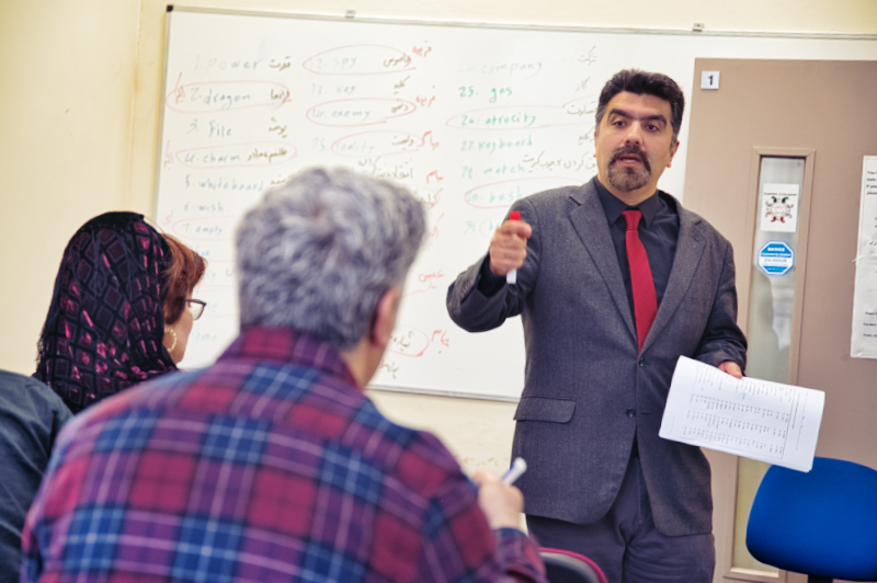 Man in a suit teaching a class